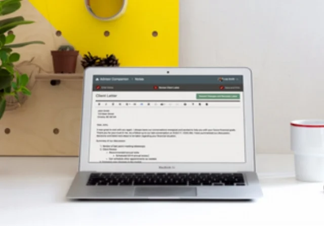 Reviewing a planning letter on a laptop